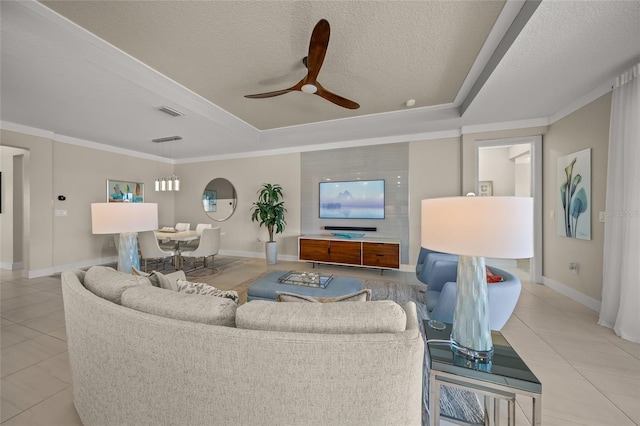 living room featuring light tile patterned floors, a raised ceiling, and a textured ceiling