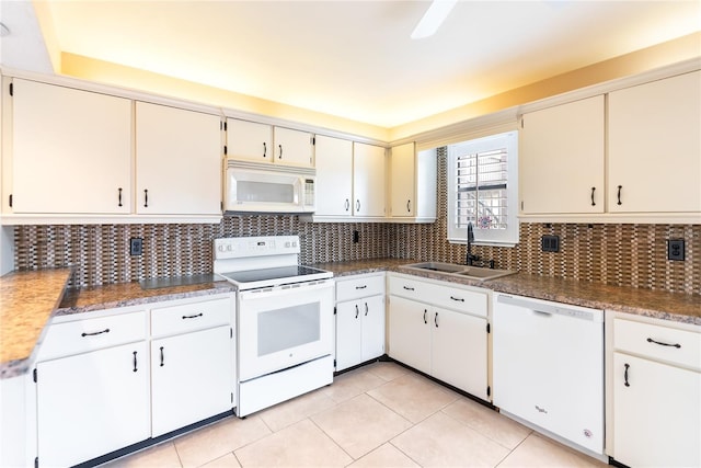 kitchen featuring white appliances, tasteful backsplash, white cabinetry, light tile patterned floors, and sink