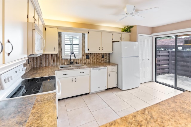 kitchen with white appliances, sink, backsplash, light tile patterned floors, and cream cabinetry