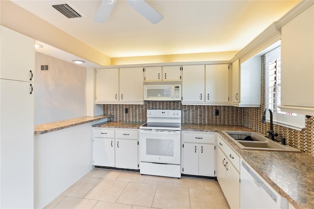 kitchen with ceiling fan, white appliances, light tile patterned floors, sink, and backsplash