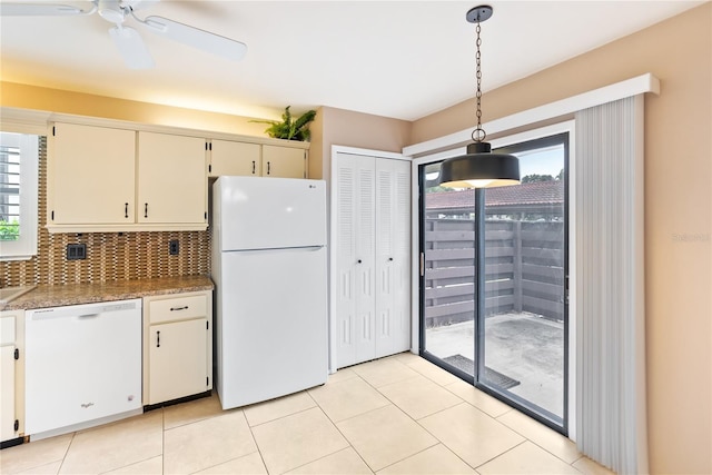 kitchen featuring pendant lighting, white appliances, light tile patterned floors, and decorative backsplash