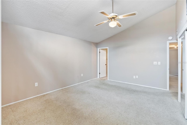 spare room with ceiling fan, light colored carpet, a textured ceiling, and lofted ceiling