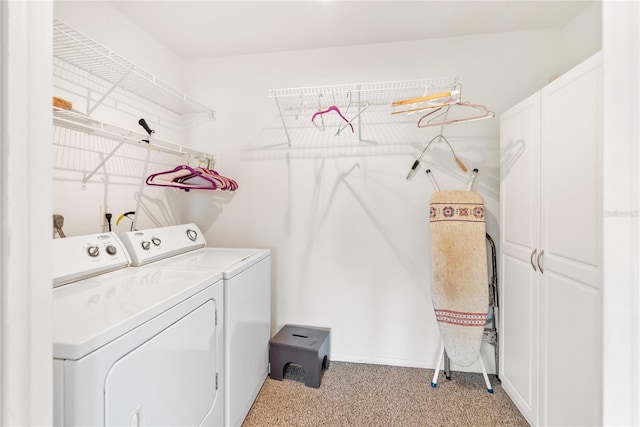 clothes washing area featuring separate washer and dryer and light carpet