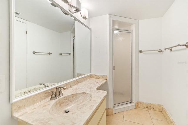 bathroom featuring a shower with door, vanity, and tile patterned flooring