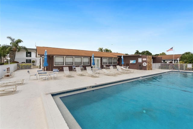 rear view of property with a patio and a community pool