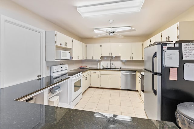 kitchen with appliances with stainless steel finishes, white cabinetry, sink, ceiling fan, and light tile patterned flooring