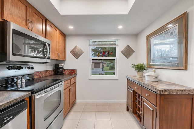 kitchen featuring light tile patterned floors and stainless steel appliances