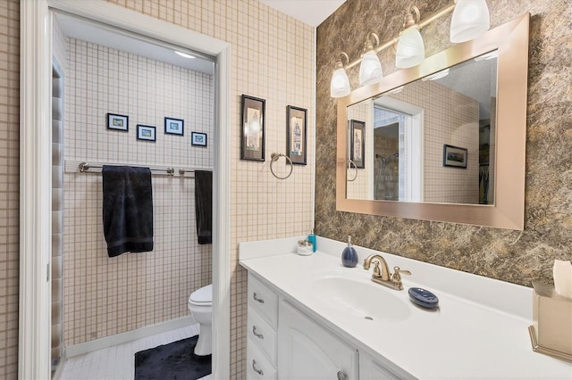 bathroom with tile patterned flooring, vanity, and toilet