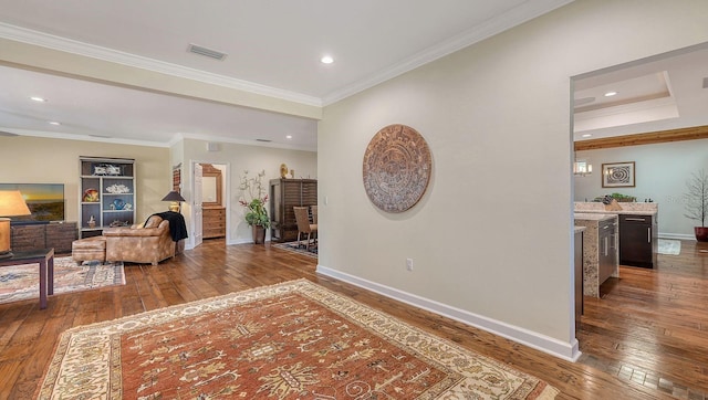 hallway with ornamental molding and hardwood / wood-style floors