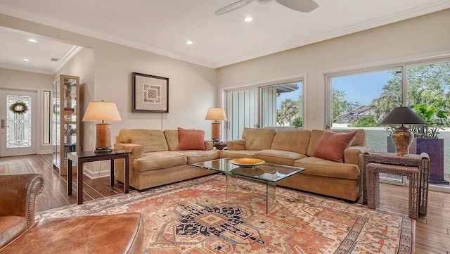 living room with crown molding, wood-type flooring, and ceiling fan