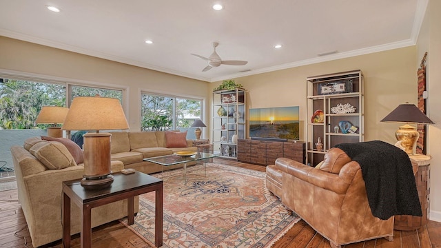 living room featuring ceiling fan, ornamental molding, and hardwood / wood-style floors