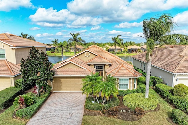 view of front of house with a garage and a water view