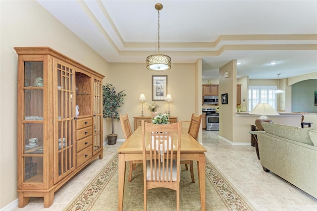 dining room with a raised ceiling