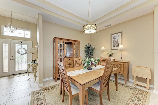 dining room with a notable chandelier and light tile patterned floors