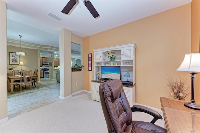 carpeted home office featuring ceiling fan