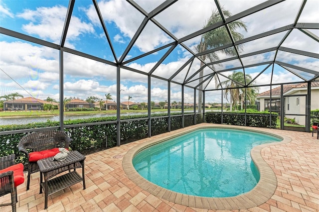 view of pool with a patio, a water view, and a lanai