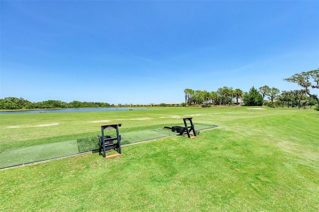 surrounding community featuring a water view and a lawn