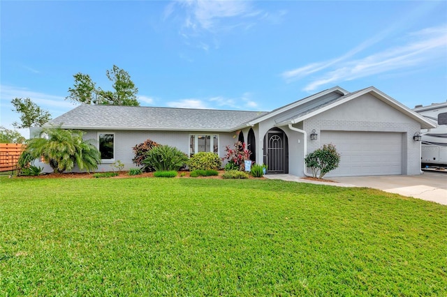 single story home with a garage and a front lawn