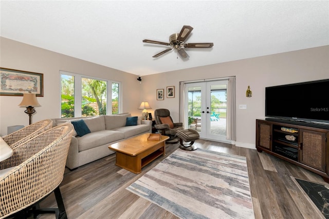 living room featuring french doors, a healthy amount of sunlight, dark hardwood / wood-style floors, and a textured ceiling