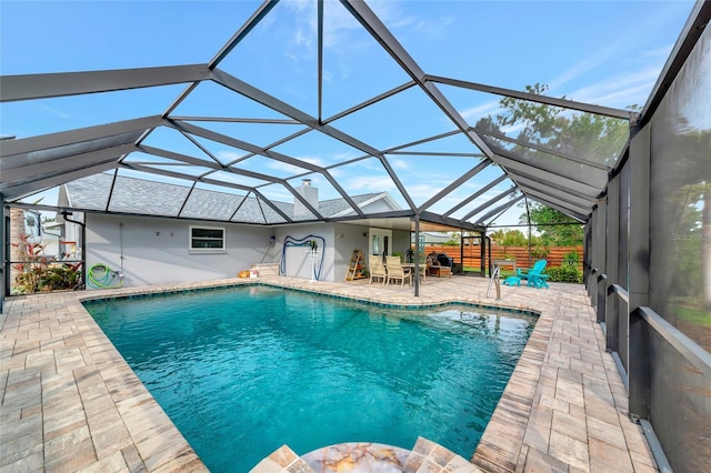 view of swimming pool with a patio and a lanai