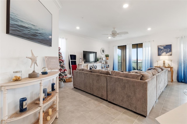 living room featuring ceiling fan and ornamental molding