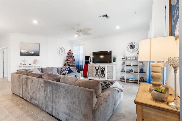 tiled living room with ceiling fan and crown molding