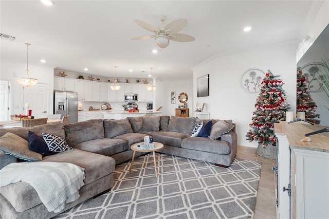 tiled living room featuring ceiling fan and crown molding