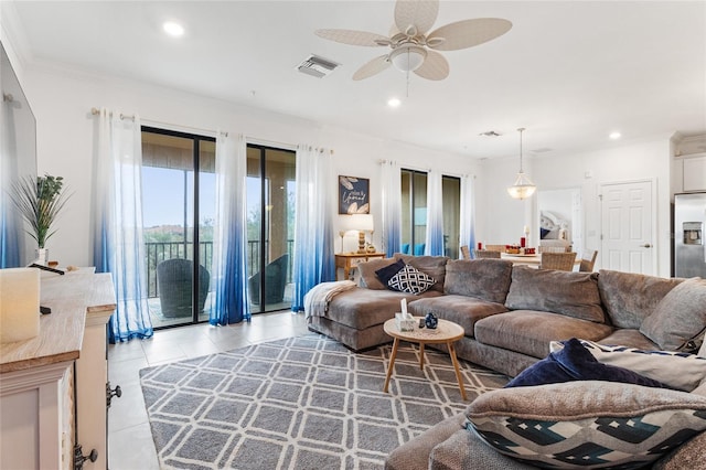 living room featuring crown molding, light tile patterned flooring, and ceiling fan