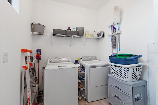 laundry room featuring separate washer and dryer and light tile patterned floors