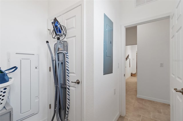 interior space with light tile patterned floors and electric panel