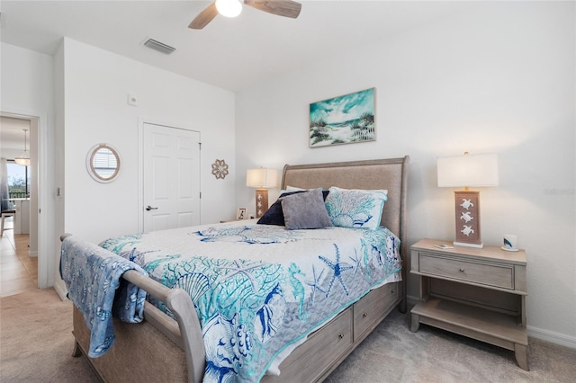 bedroom featuring ceiling fan and light carpet