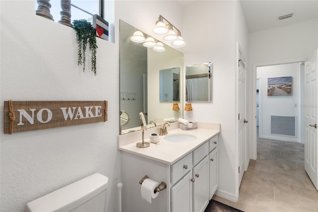 bathroom featuring toilet and vanity