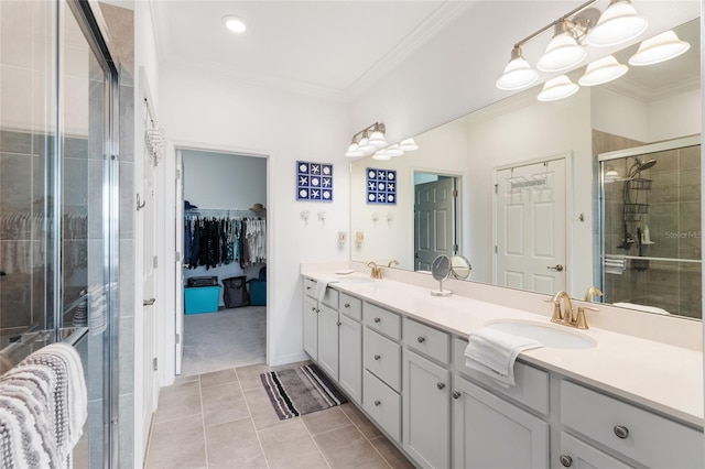 bathroom featuring tile patterned floors, an enclosed shower, vanity, and ornamental molding