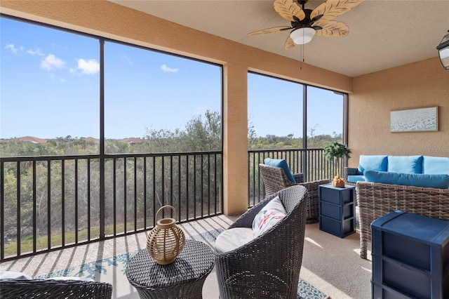 sunroom / solarium featuring ceiling fan