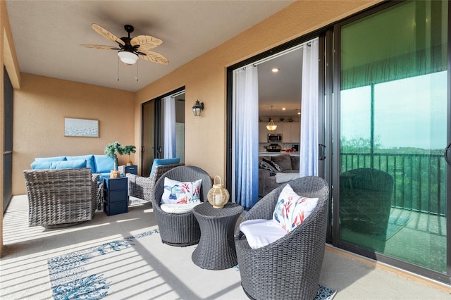 balcony featuring an outdoor hangout area and ceiling fan