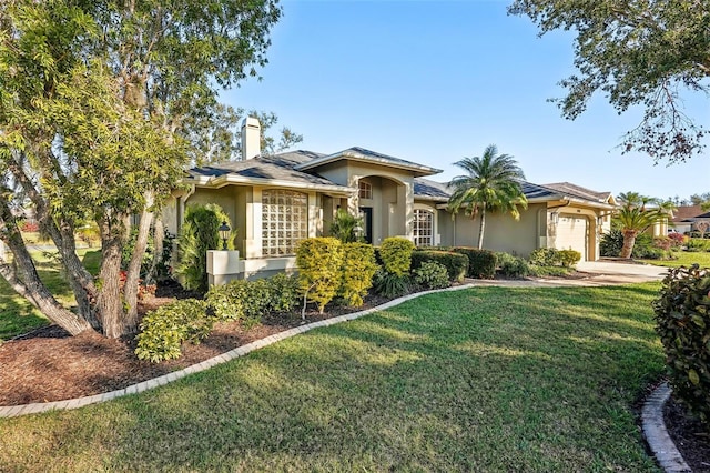 ranch-style home featuring a garage and a front yard