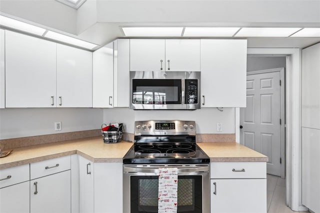 kitchen with white cabinetry and stainless steel appliances