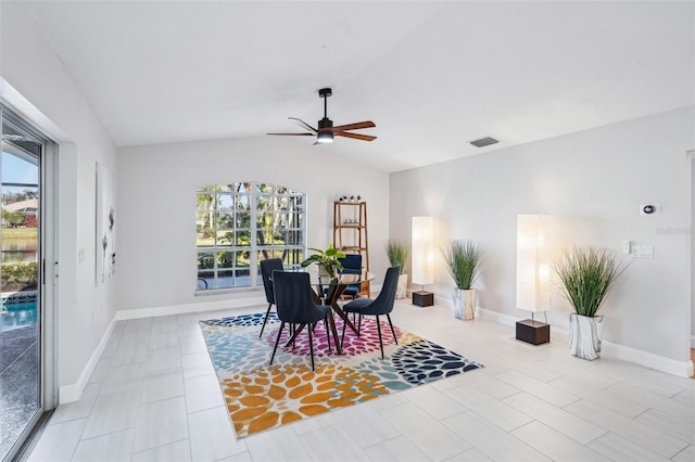 dining room with lofted ceiling, light tile patterned floors, plenty of natural light, and ceiling fan