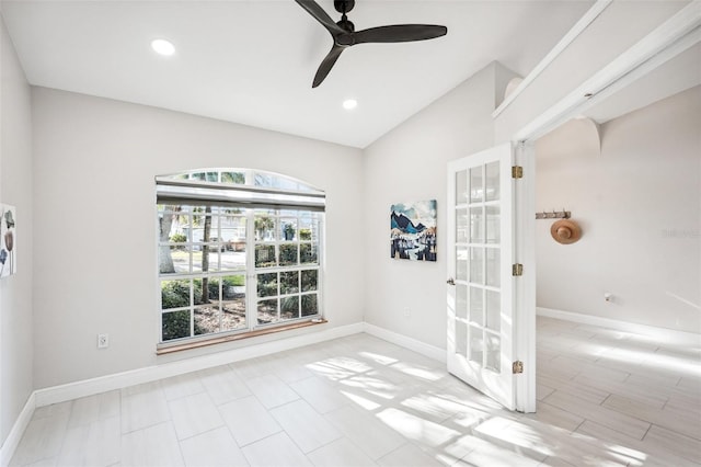 empty room featuring vaulted ceiling and ceiling fan