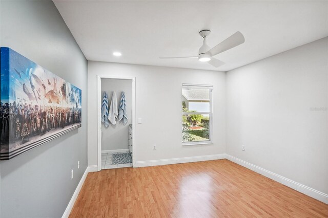 unfurnished room featuring light hardwood / wood-style floors and ceiling fan