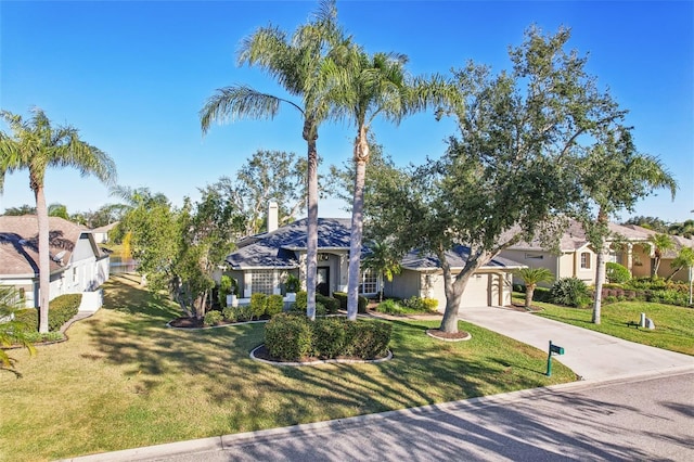 view of front of property with a garage and a front lawn