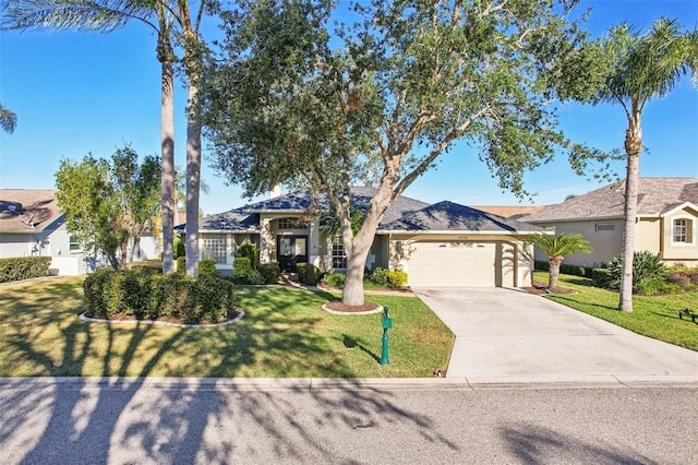 ranch-style house with a garage and a front lawn