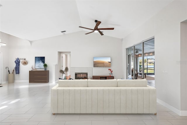 living room with lofted ceiling, light tile patterned floors, and ceiling fan