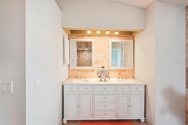 bathroom featuring tasteful backsplash and vanity