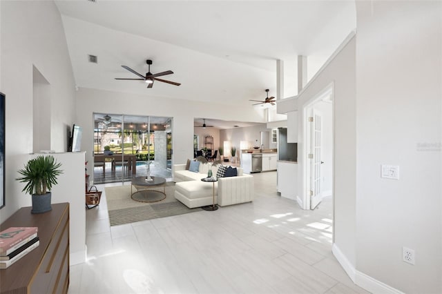 living room featuring vaulted ceiling and ceiling fan