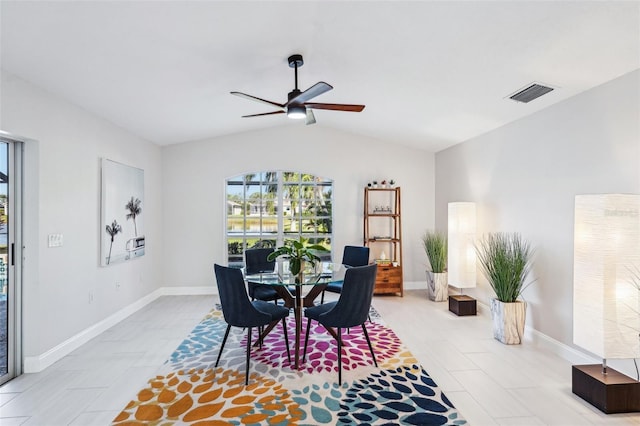 dining space featuring ceiling fan and lofted ceiling