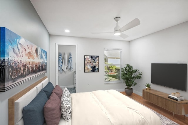 bedroom with wood-type flooring and ceiling fan