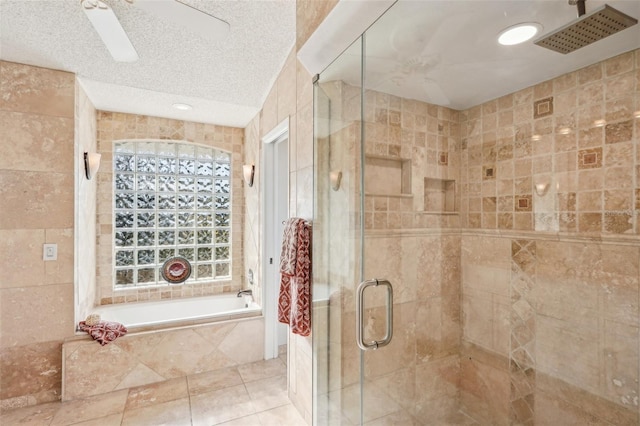 bathroom with tile patterned flooring, ceiling fan, separate shower and tub, and a textured ceiling