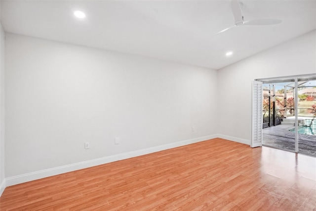 unfurnished room with ceiling fan, lofted ceiling, and light wood-type flooring