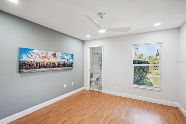 unfurnished bedroom featuring connected bathroom, light hardwood / wood-style floors, and ceiling fan